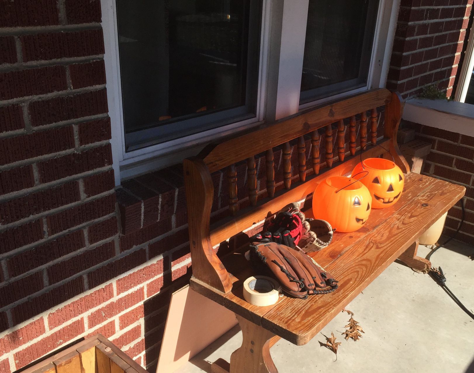 Baseball gloves and trick-or-treating buckets on front porch